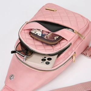 Internal capacity of pink quilted crossbody chest bag showing storage for sunglasses