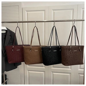 Detail of leopard print tote bags in four colors with elegant metal bar accents