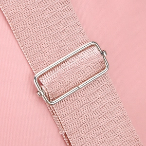 Detailed close-up of pink shoulder strap with adjustable silver metal buckle on bag