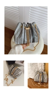Detail of woven bucket bag with pearl chain strap and drawstring closure