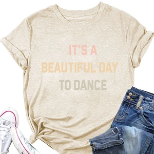 Flat lay of beige 'IT'S A BEAUTIFUL DAY' crew neck T-shirt with jeans and white shoes
