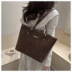 Detail of leopard print tote bag featuring fuzzy suede texture and gold metal accent
