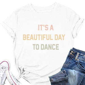 Flat lay of white t-shirt with colorful text styled with denim shorts and canvas shoes