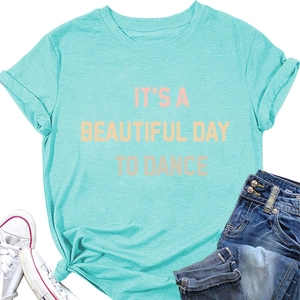 Detail of mint green T-shirt with 'IT'S A BEAUTIFUL DAY' text and denim jeans