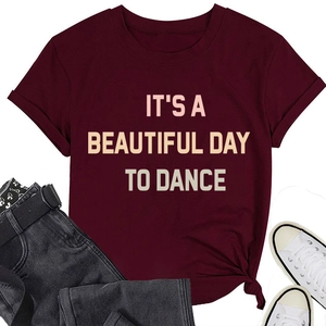 Flat lay of burgundy t-shirt with slogan and jeans with white canvas shoes