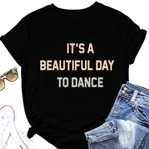 Flat lay of black crew neck t-shirt with colorful slogan and casual accessories