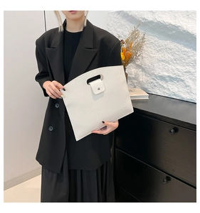 Minimalist white litchi pattern laptop briefcase held by a model in a black suit