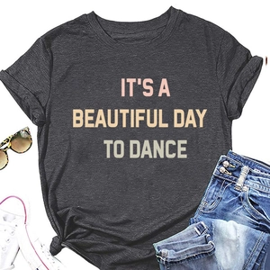 Flat lay of charcoal gray crewneck t-shirt with pink and beige dance slogan print