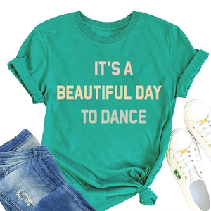 Flat lay of light green crew neck T-shirt with 'IT'S A BEAUTIFUL DAY TO DANCE' print