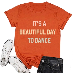 Flat lay of orange slogan T-shirt with denim shorts and white canvas sneakers