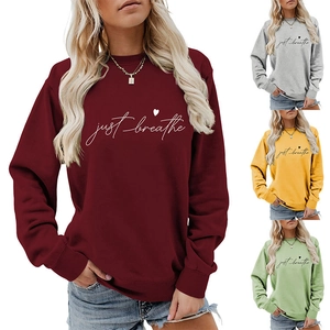 Detail of Just Breathe heart sweatshirt in burgundy, grey, yellow, and avocado green