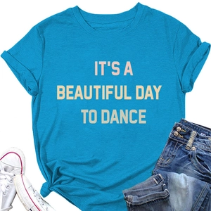 Flat lay of bright blue T-shirt with 'IT'S A BEAUTIFUL DAY TO DANCE' slogan print