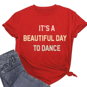 Close-up of red cotton T-shirt featuring IT'S A BEAUTIFUL DAY TO DANCE slogan print