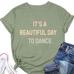 Flat lay of bean green cotton t-shirt featuring IT'S A BEAUTIFUL DAY TO DANCE slogan