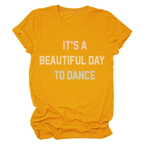 Close-up of ginger yellow cotton T-shirt with 'IT'S A BEAUTIFUL DAY TO DANCE' print