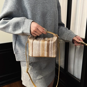 Ethnic style striped woven handbag with gold thread details and leather shoulder strap