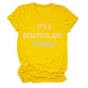 Detail of bright yellow crewneck t-shirt with pink IT'S A BEAUTIFUL DAY text slogan