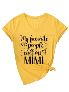 Detail of V-neck mustard yellow t-shirt featuring Mimi print and knotted hem design