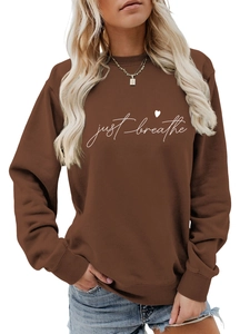 Detail of just breathe text and heart print on coffee brown crewneck sweatshirt