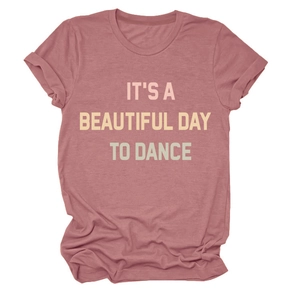 Close-up of dusty pink t-shirt featuring IT'S A BEAUTIFUL DAY TO DANCE printed design