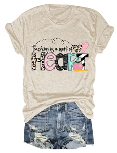 Detail of Teaching is a work of Heart print on beige T-shirt with denim shorts