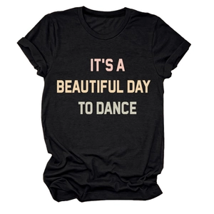 Detail of a black cotton t-shirt with pink and green IT'S A BEAUTIFUL DAY TO DANCE text