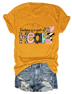 Flat lay of mustard yellow Heart graphic T-shirt with distressed blue denim shorts