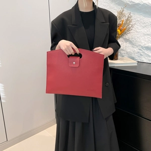 Red leather envelope handbag with oval cut-out handle for minimalist fashion style