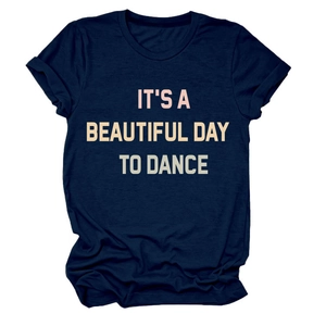 Detail of rolled sleeves and pink slogan print on navy blue cotton t-shirt