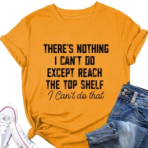 Flat lay of cotton yellow t-shirt with slogan, white sneakers and denim jeans