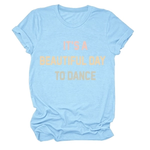 Close-up of sky blue cotton T-shirt with pink and yellow dance slogan and rolled cuffs