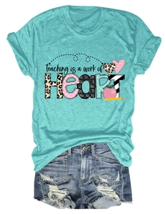 Flat lay of blue Teaching is a Work of Heart t-shirt with distressed denim shorts