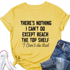 Flat lay of yellow crew neck T-shirt with black text print and casual denim accessories