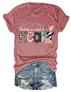 Close-up of Teaching is a work of Heart graphic print on red cotton t-shirt