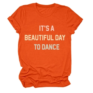 Detailed view of bright orange crewneck T-shirt featuring IT'S A BEAUTIFUL DAY print