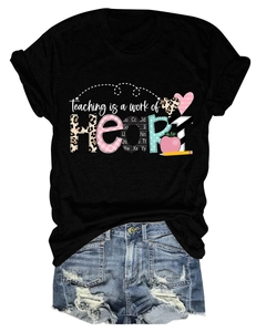 Detail of Teaching is a work of HEART print on a black women's cotton t-shirt