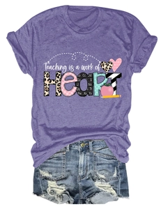 Flat lay of purple crew neck T-shirt with HEART graphic and distressed denim shorts