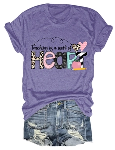 Detail of Teaching is a Work of Heart print on purple crew neck teacher t-shirt