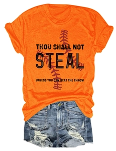 Detail of orange t-shirt with baseball slogan and ripped denim shorts ensemble
