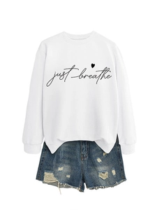 Detail of Just Breathe script and heart print on a white casual long sleeve sweatshirt