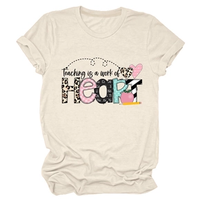 Detail of cream t-shirt showing Teaching is a work of Heart artistic print and fabric