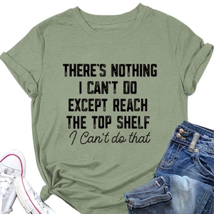 Detail of green T-shirt with black slogan print, styled with denim jeans and sneakers