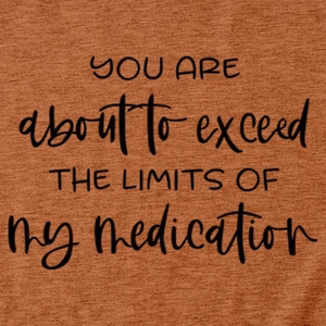Close-up of brick red cotton T-shirt showing printed black artistic text detail
