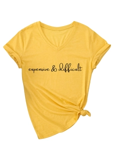Detail of bright yellow V-neck T-shirt featuring expensive difficult text and side knot