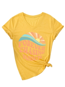 Detail view of yellow V-neck T-shirt with sunset print and stylish front hem knot