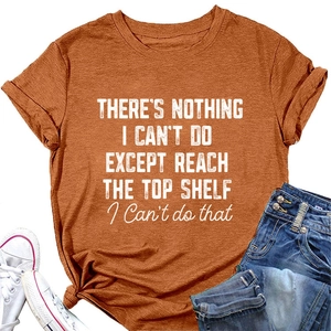 Flat lay of caramel cotton T-shirt with humorous quote and denim shorts in casual style