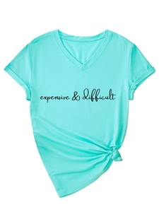 Detail view of the V-neck mint green tee with black expensive & difficult text and hem knot