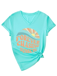 Detail of V-neck mint green T-shirt with orange sun and sunset graphic print