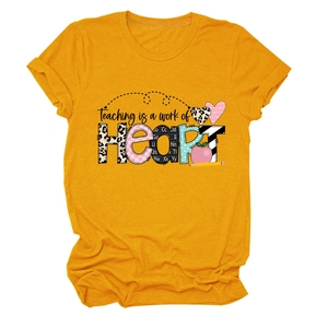 Macro detail of mustard yellow cotton T-shirt featuring artful Teaching is a work of Heart print