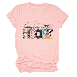 Detail of pink crew neck t-shirt featuring teaching is a work of heart graphic print